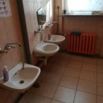 Stare umywalki w pomieszczeniu sanitarnym.