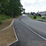 Nowy chodnik wzdłuż drogi powiatowej. Po lewej stronie tereny zielone.