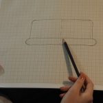 Kobieta rysująca schemat na kartce papieru.